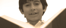 young boy reads a book