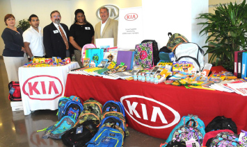 KIA representatives with school supplies for Harris County students