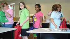 Volunteers packing and assembling bags for the 11th annual Back To School Rush